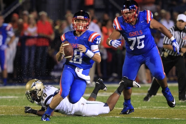 Bishop Gorman quarterback Tate Martell scrambles past St. John Bosco defensive back Bryce Tu ...