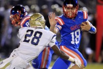 Bishop Gorman quarterback Tate Martell scrambles away from St. John Bosco defensive back Tra ...