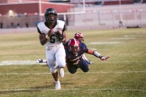 Palo Verde running back Christian Bell averts a diving tackle attempt by Coronado‘s Ju ...