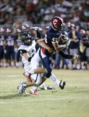 Coronado High School Senior Miguel Pena (43) tries to gain more yardage as Palo Verde High S ...