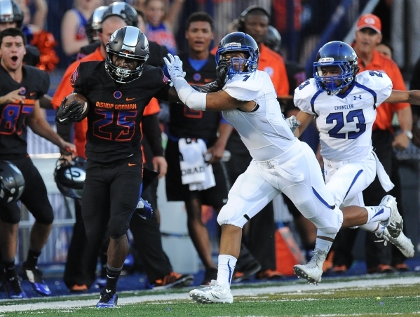 Bishop Gorman wide receiver Tyjon Lindsey (25) stiff-arms Chandler safety Teauntae Nash (7) ...