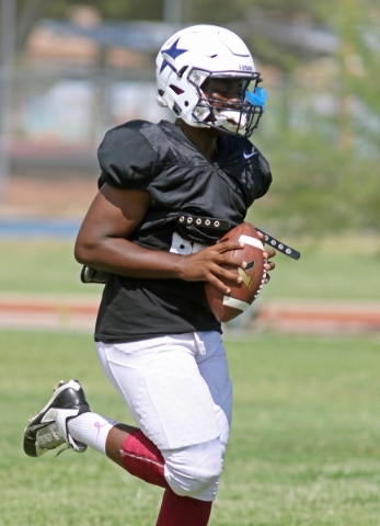 Agassi Prep senior quarterback Kameron Burrell runs with the ball during practice at Doolitt ...