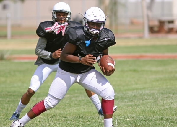 Agassi Prep quarterback Kameron Burrell, front, and wide receiver Zeivaun Ned warm up Wednes ...