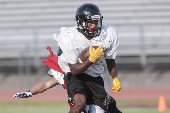 Las Vegas High School running back Elijah Hicks runs a drill during football practice at the ...