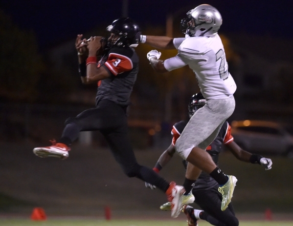 Las Vegas‘ Zachary Loveland (3) snags an interception from Green Valley‘s Brayon ...