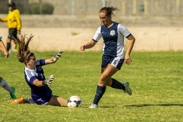 Katherine Ballou (6) of the Foothill Falcons takes the ball past Mikaila Becze of the Silver ...