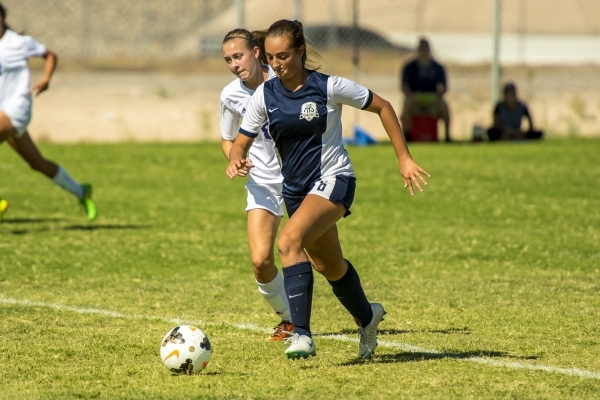 Katherine Ballou (6) of the Foothill Falcons takes the ball past Kayla McGinnis of the Silve ...