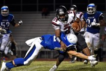 Basic‘s Kyle Grismanauskas (2) dives for the tackle against Desert Oasis‘ Ty&lsq ...