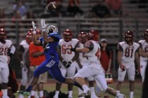 Green Valley wide receiver Brayon Williams catches a pass as Arbor View safety Andrew Wagner ...