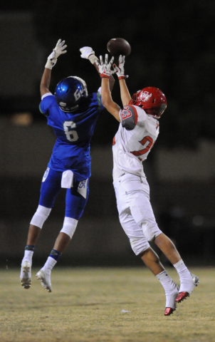 Green Valley safety Kaleb Ramsey (6) breaks up a pass intended for Arbor View wide receiver ...