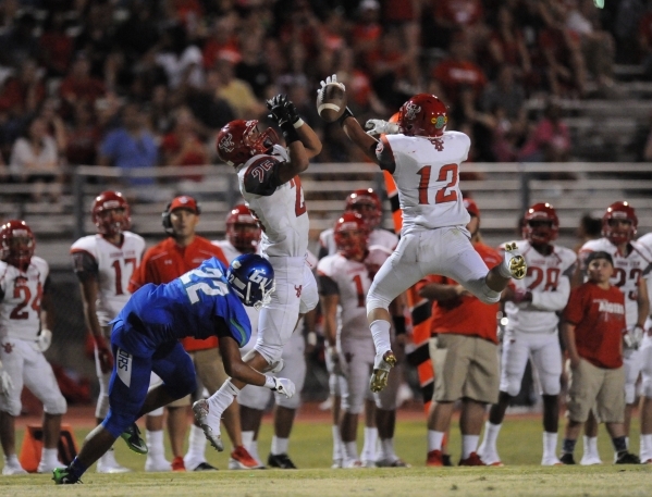 Arbor View safety Staycee Robinson (25) and defensive back Noah Noce (12) break up a pass in ...