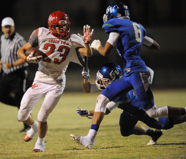 Arbor View running back Deago Stubbs (23) stiff-arms Grenn Valley safety Kaleb Ramsey (6) to ...