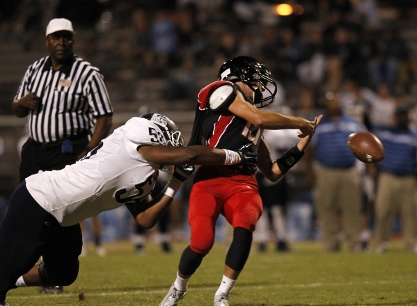 Centennial defensive lineman Greg Rogers tackles Las Vegas quarterback Trevor Swenson at Las ...