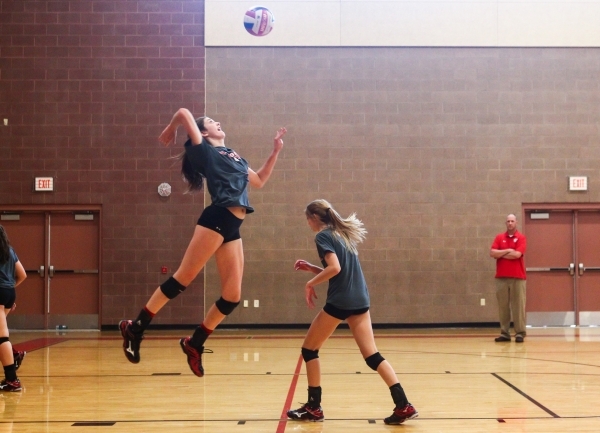 Arbor View outside hitter Hannah Goddard, left, jumps to serve the ball during volleyball pr ...