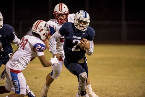 Centennial Bulldogs quarterback Jamaal Evans (2) runs with the ball against the Liberty Patr ...