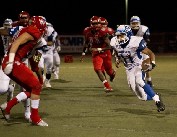 Basic High School quarterback Tank McAllister takes the ball downfield against Basic High Sc ...