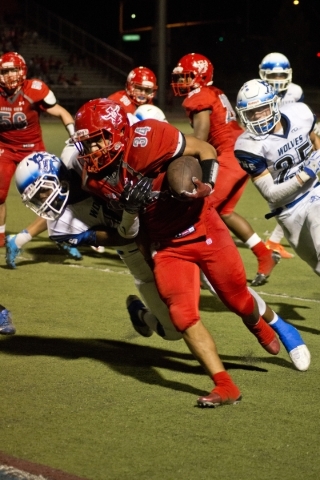 Arbor View High School running back Morris Jackson is tackled by Basic High School‘s D ...