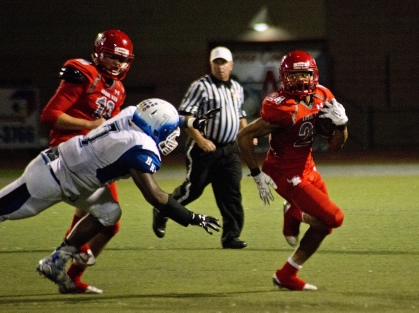 Arbor View High School running back Curtis Jones outruns Basic High School player Kendahl Bl ...