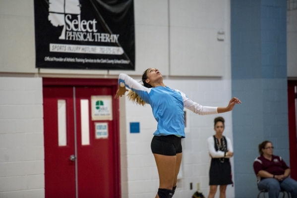 Destiny Gonzalez of Western High School serves the ball against Faith Lutheran High School a ...