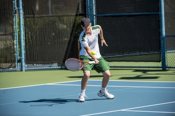 Mackay Boman of Green Valley High School hits a forehand against Kyle Harris of Coronado Hig ...