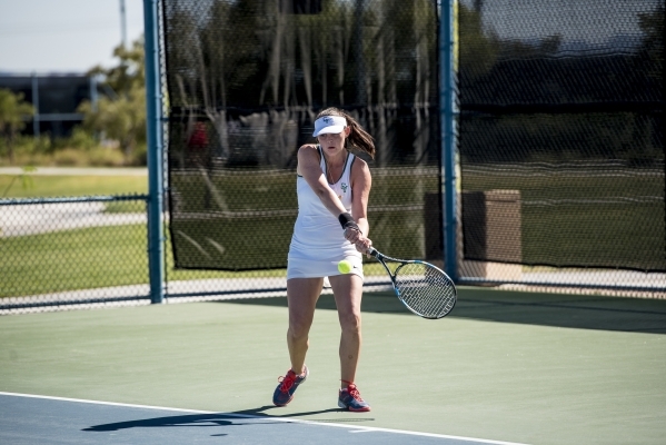 Racquel Holder of Green Valley High School hits a backhand against Marisa Olmos of Liberty H ...