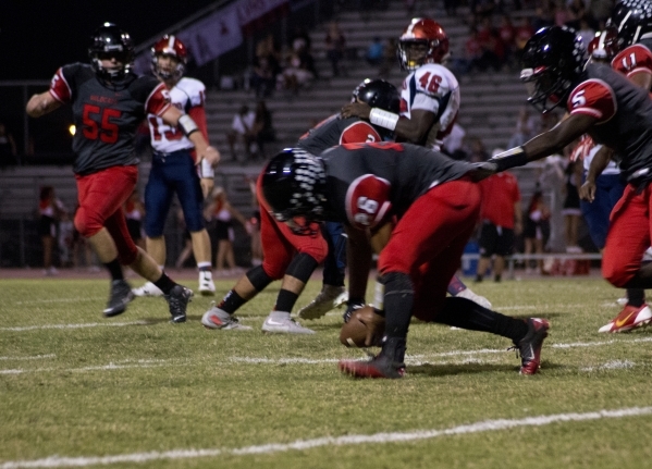 Las Vegas‘ Josh Perez (26) picks up a Coronado fumble during their prep football game ...