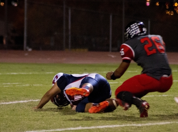 Coronado‘s Adolfo Sandoval (77) attempts to recover a high snap as Las Vegas‘ Jo ...