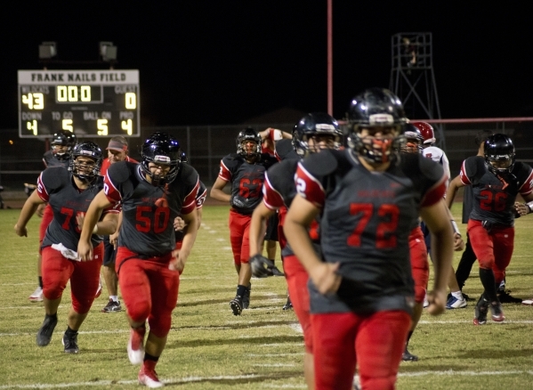 The Las Vegas High School football team celebrates their win after their prep football game ...