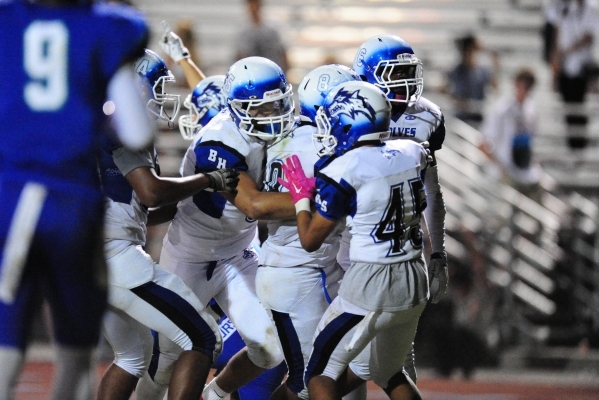 Basic Wolves cornerback Deondre Ishman, (6) and teammates celebrate Ishman‘s game winn ...