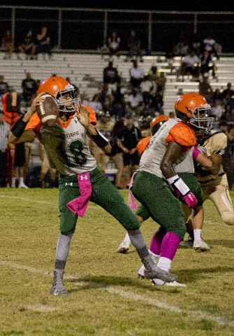 Mojave quarterback Kyle McMillan (18) drops back for a pass during their prep football game ...