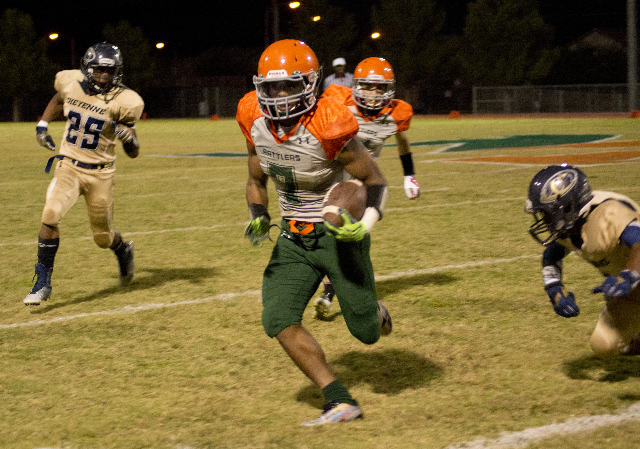 Mojave‘s Khalid Walker (7) runs the ball up field during their prep football game agai ...