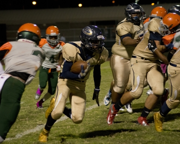 Mojave‘s Elijah Smoot (3) extends the ball for more yardage at the end of a run during ...