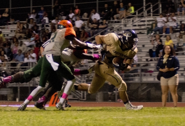 Mojave running back Elijah Smoot (3) lies injured on the field during their prep football ga ...