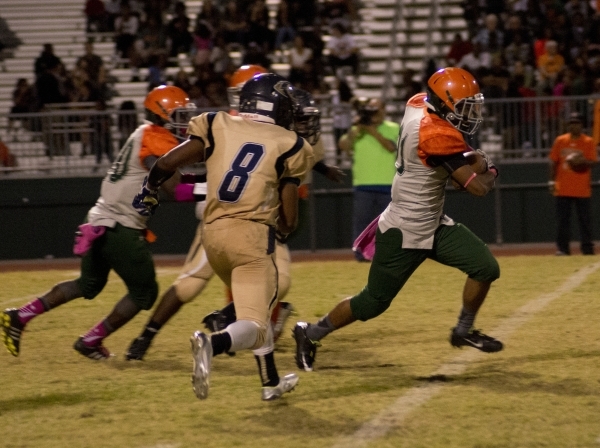 The helmet of injured Mojave player Elijah Smoot (3) remains on the field while he is tended ...