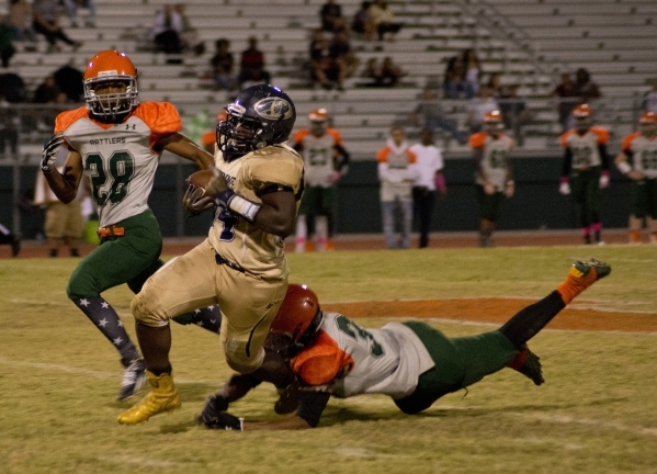 Cheyenne‘s David Walker (34) breaks tackles during a run downfield during their prep f ...