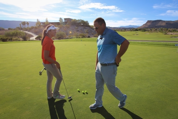 Bishop Gorman sophomore Hunter Pate, left, talks with head coach Jim Stanfill, right, during ...