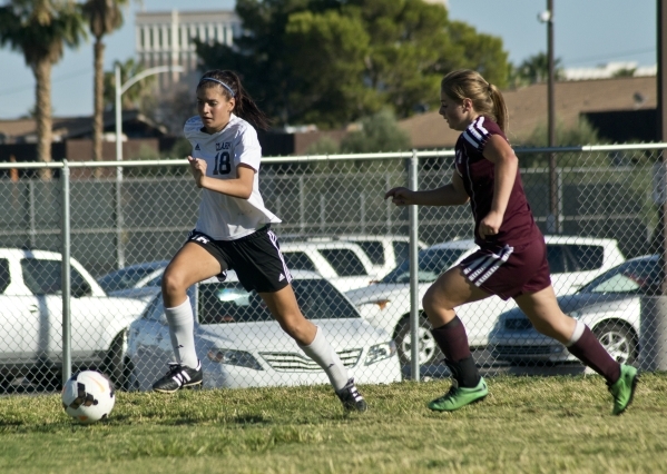 Clark High School‘s Ariana Reyes (18) works the ball upfield while pursued by Pahrump ...