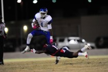 Green Valley Gators wide receiver Marquez Powell (1) breaks the tackle of Coronado Cougars d ...