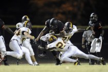 Chaparral running back Richard Nelson, center, is tackled by Eldorado linebackers Trayvion P ...