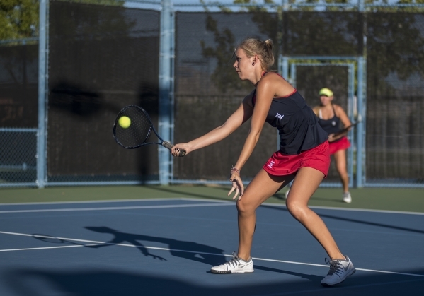 Parker Burk from Liberty High School plays in a doubles match with her twin sister Payton du ...