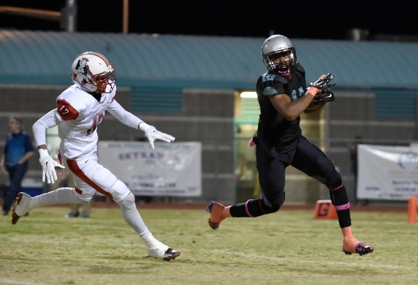 Silverado‘s Devion Clayton, right, avoids Liberty‘s Deseon Trotter during the fi ...