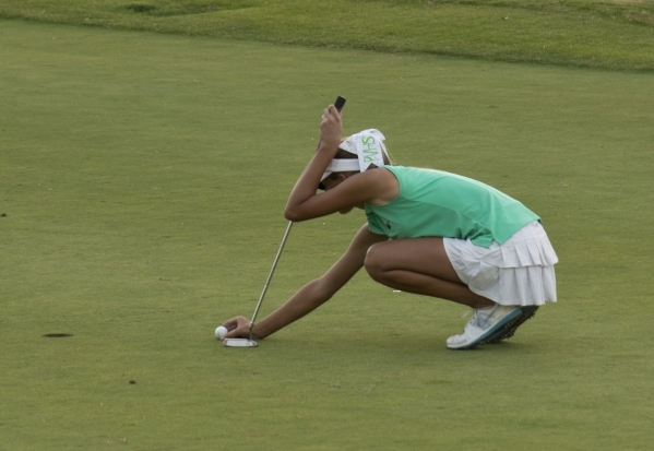 Annick Haczkiewicz of Palo Verde High School places her ball on the green during the last ho ...