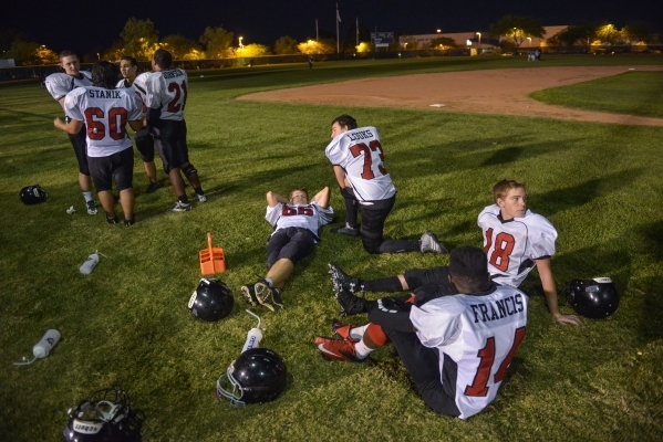 Mountain View Christian High School football players meet on the baseball field behind the f ...