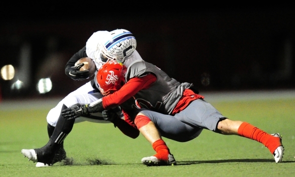 Arbor View defensive back Noah Noce tackles Centennial running back Rhamondre Stevenson in t ...