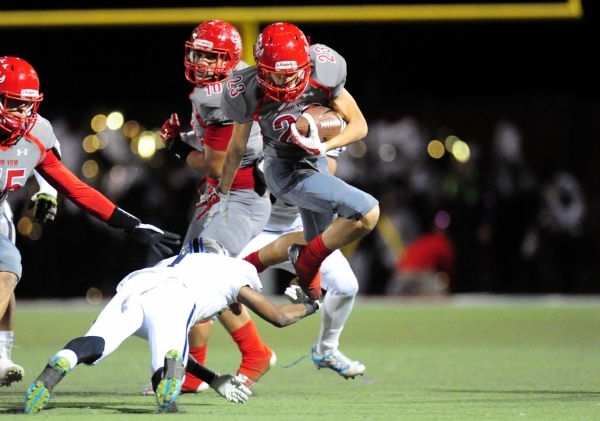 Arbor View running back defensive back Deago Stubbs jumps over Centennial cornerback Demetri ...