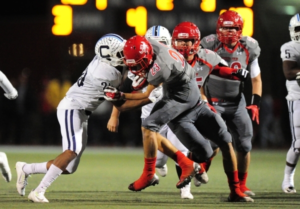 Arbor View running back Deago Stubbs runs into Centennial linebacker Joshua Campbell while r ...