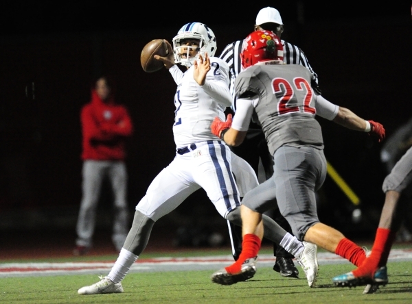 Centennial quarterback Jamaal Evans (2) passes while on the run while being chased by Arbor ...