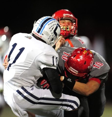 Arbor View linebacker Bishop Jones (10) and Arbor View fullback linebacker Andrew Wagner tac ...