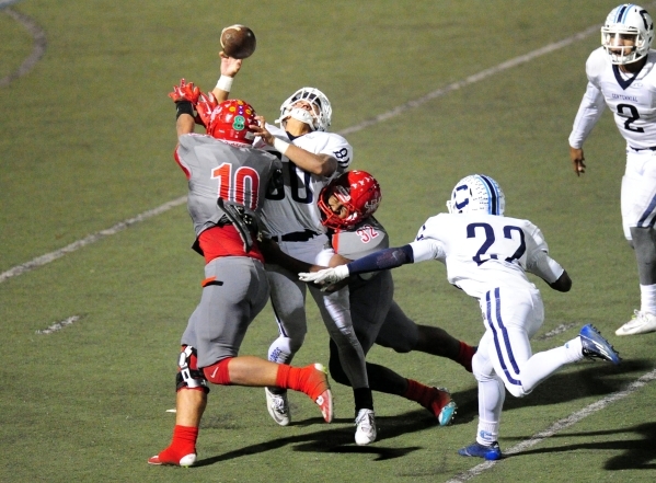 Centennial wide receiver Tyler Hennis is hit by Arbor View linebacker Bishop Jones Arbor (10 ...