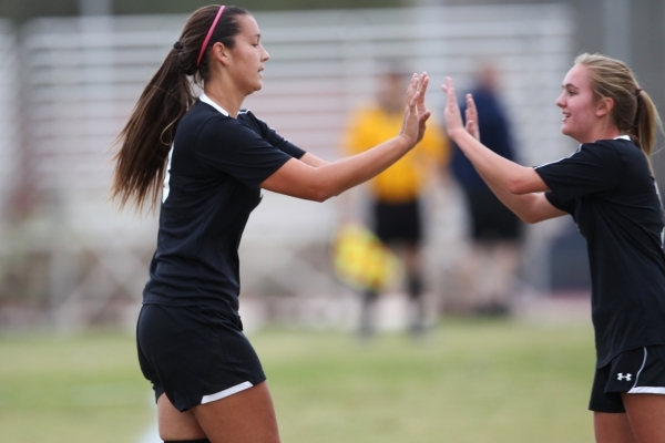 Palo Verde‘s Jadyn Nogues (18), left, high fives her teammate Elissa Young in celebrat ...